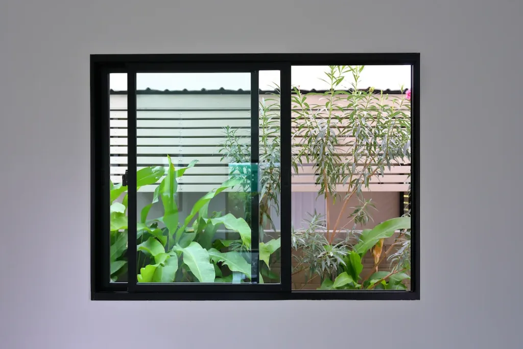 glass slide window replacement on white wall of a new house