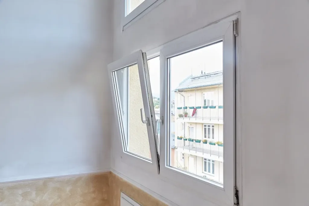 Window tilt open in a city apartment, letting in fresh air