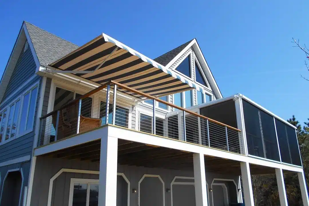 Eclipse patio awning system with custom fabric pattern for residential outdoor entertainment area