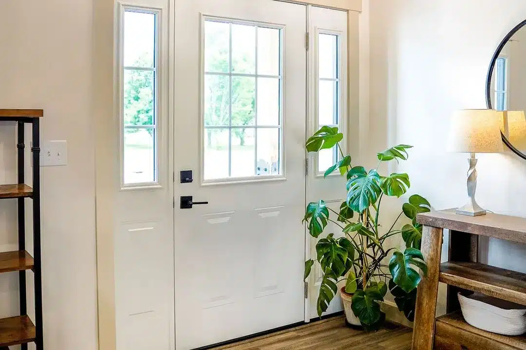Legacy smooth steel entry door in snow mist white with colonial grids and classic design