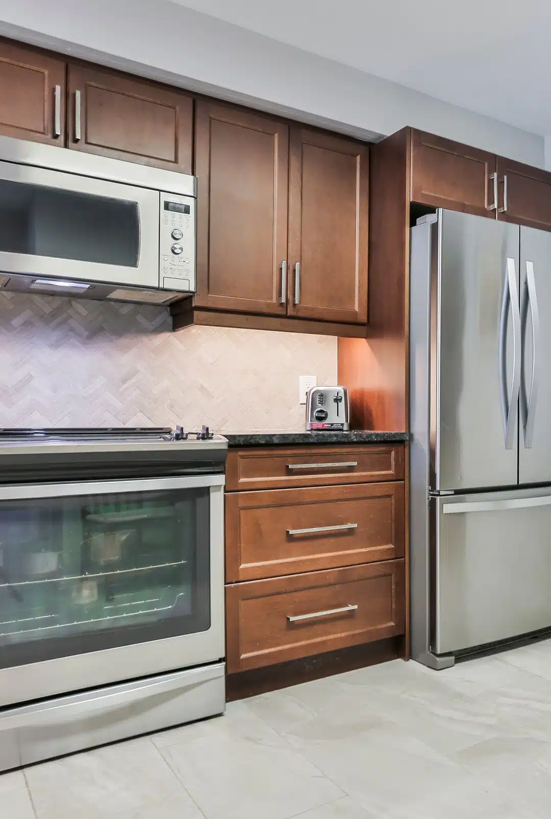 Contemporary studio kitchen with granite countertops and stainless appliances